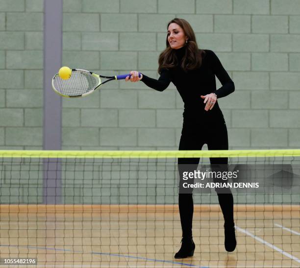 Britain's Catherine, Duchess of Cambridge, plays tennis as she joins a session with a group during a visit the Coach Core Essex apprenticeship scheme...