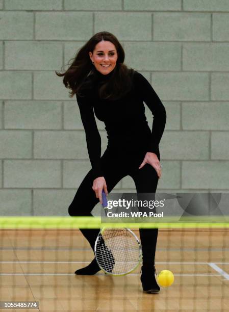 Catherine, Duchess of Cambridge, plays tennis as she joins a session with a group as they join a session during a visit to the Coach Core Essex...