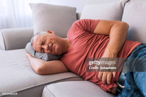 man suffering from stomachache - indigestion stock pictures, royalty-free photos & images