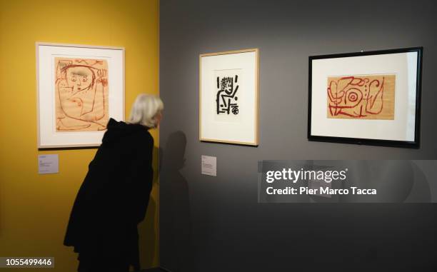Woman looks at the paint 'Undercover' by Paul Klee at the "Paul Klee. Alle Origini Dell'Arte" exhibition preview at MUDEC on October 30, 2018 in...