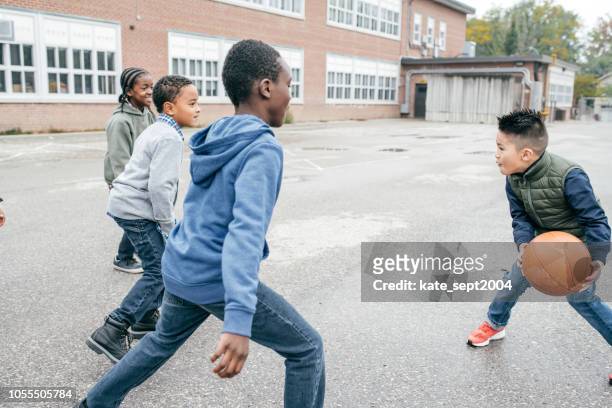 little students playing basketball - boys basketball stock pictures, royalty-free photos & images