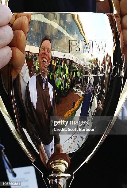 Jockey Chris Munce is reflected in the Caulfield Cup during the presentations after Descarado won race 8 the BMW Caulfield Cup during Caulfield Cup...