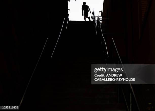 Man exercises on the stairs made famous by the 1973 movie "The Exorcist" in Georgetown in Washington, DC, on October 29, 2018. - The 75 steps served...