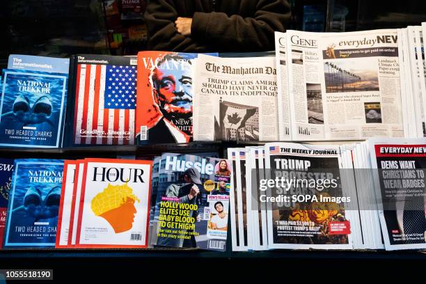 News papers containing fake headlines and books containing fake articles are seen displayed on a news stand at the times square. The...