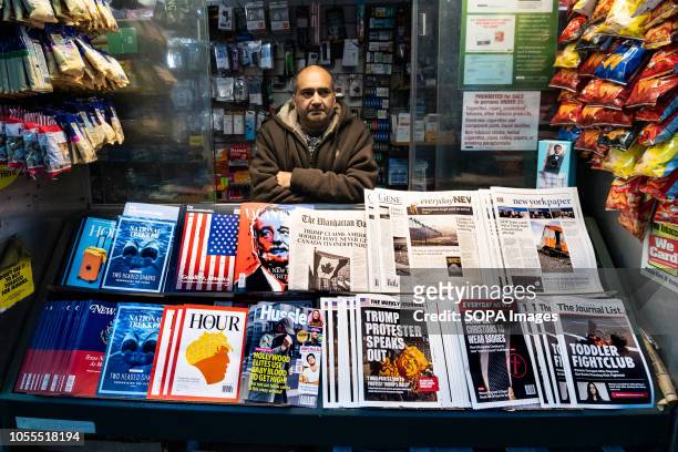 News papers containing fake headlines and books containing fake articles are seen displayed on a news stand at the times square. The...