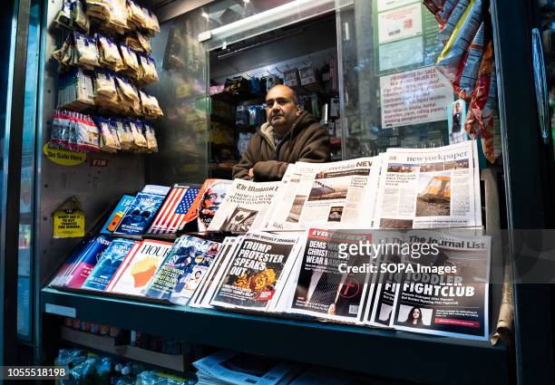 News papers containing fake headlines and books containing fake articles are seen displayed on a news stand at the times square. The...