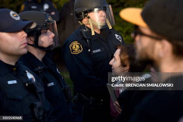 Riot police block protesters as they near the Tree of Life Congregation on October 30, 2018 in Pittsburgh, Pennsylvania. - Scores of protesters took...