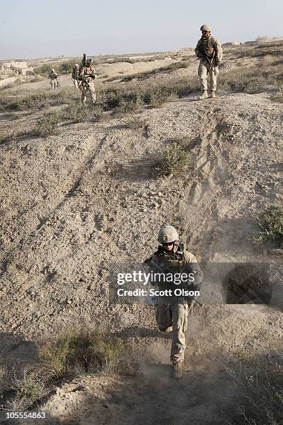 Marines with India Battery, 3rd Battalion, 12th Marine Regiment work their way back from an overnight patrol near Forward Operating Base Zeebrugge on...