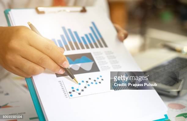 business documents on office table with smart phone and digital tablet and graph financial with social network diagram and man working in the background - big sale stock pictures, royalty-free photos & images