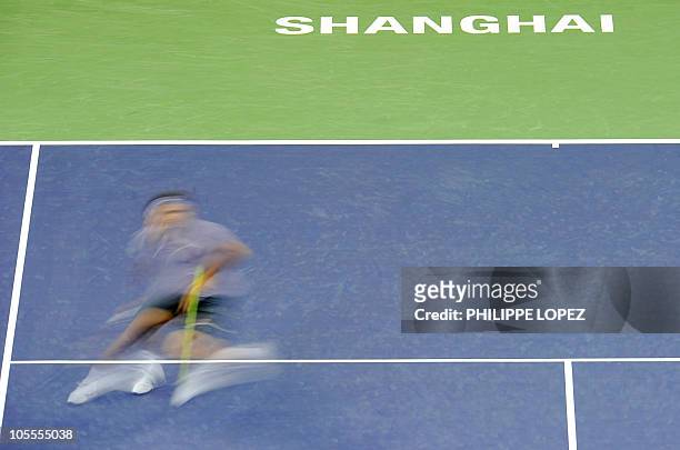 This picture taken at a slow shutter speed shows Roger Federer of Switzerland returning a shot against Novak Djokovic of Serbia during their semi...