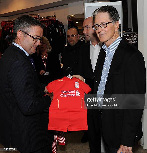 In this handout image supplied by Liverpool Football Club, John W Henry of NESV with a baby football kit in the Liverpool F.C. Shop at Anfield on...
