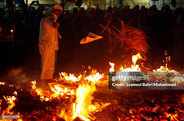 Member of the Malaysian ethnic Chinese community prepares the firewalking site on the last day of the Nine Emperor Gods Festival at a temple on...