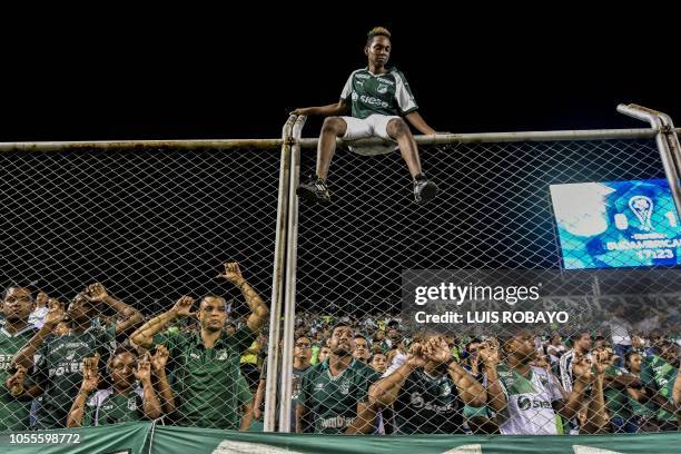 Colombia's Deportivo Cali fans react after a goal scored by Colombia's Independiente Santa Fe midfielder Uruguayan Diego Guastavino during a Copa...