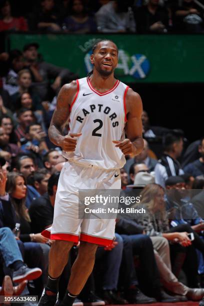 Kawhi Leonard of the Toronto Raptors smiles as he runs up court against the Philadelphia 76ers on October 30, 2018 at Soctiabank Arena in Toronto,...