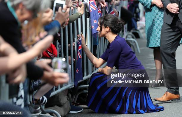 Meghan, Duchess of Sussex meets a young fan during a public walkabout at the Rotorua Government Gardens in Rotorua on October 31, 2018. - The Duke...