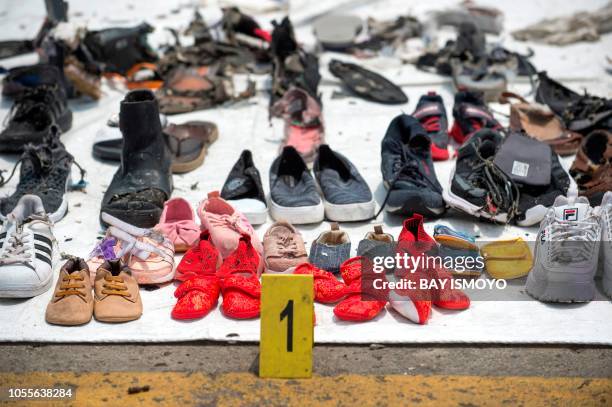 Shoes found during the search for victims from the ill-fated Lion Air flight JT 610 are collected at the Jakarta International Container Terminal in...