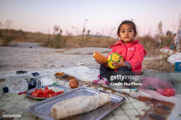 Little girl with Kurdish origins. A group of refugees outside in the field near Diavata refugee camp in Thessaloniki, Greece, on 26 October 2018....