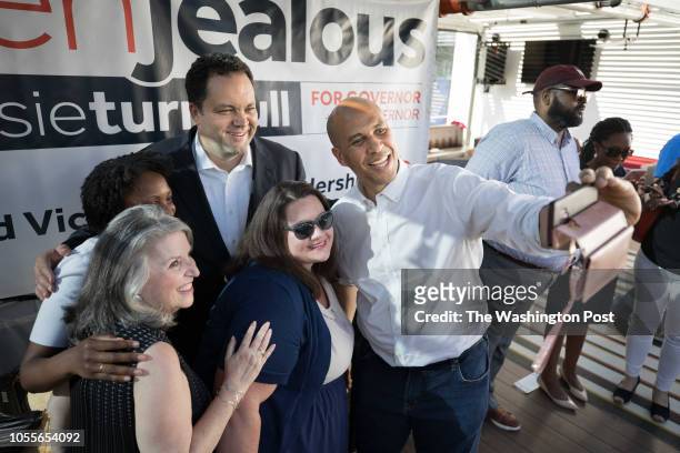 Silver Spring, Md. Candidate for Maryland Governor Ben Jealous, top center, is joined by Sen. Cory Booker, right, who takes a selfie with Jealous,...