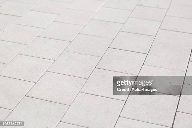background texture of square white paving tiles - steinterrasse stock-fotos und bilder