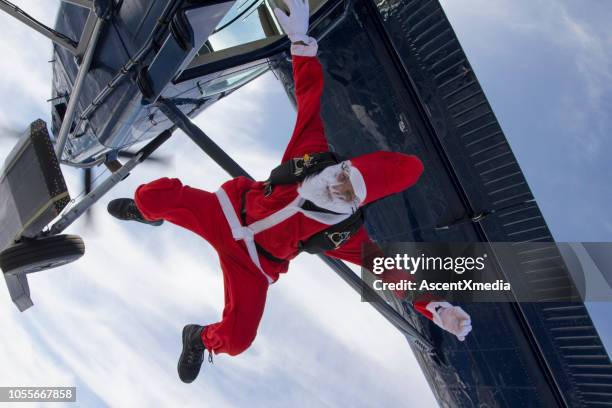 skydiver dressed as santa claus falls towards the earth - skydiving stock pictures, royalty-free photos & images