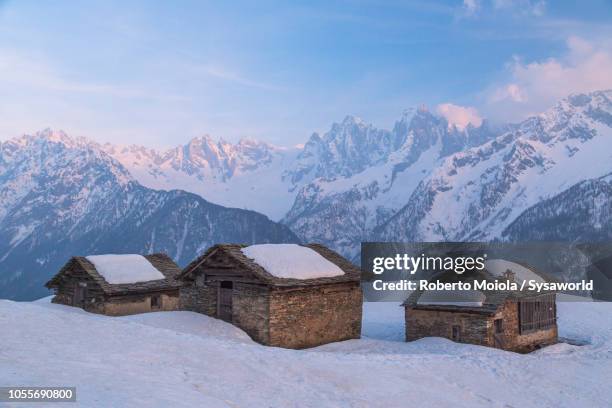 alpine huts in the snow, tombal, switzerland - wood hut stock pictures, royalty-free photos & images