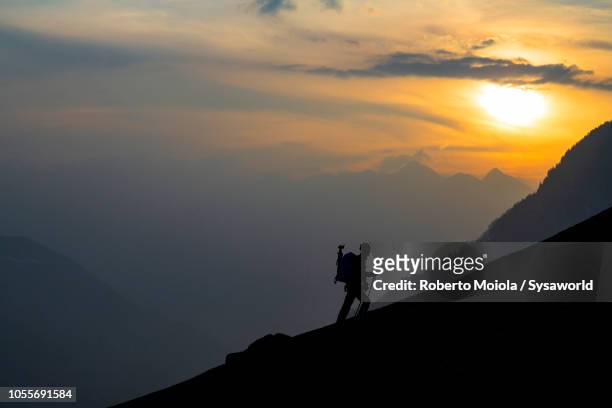 hiker at sunset, tombal, soglio, switzerland - engadin stock pictures, royalty-free photos & images