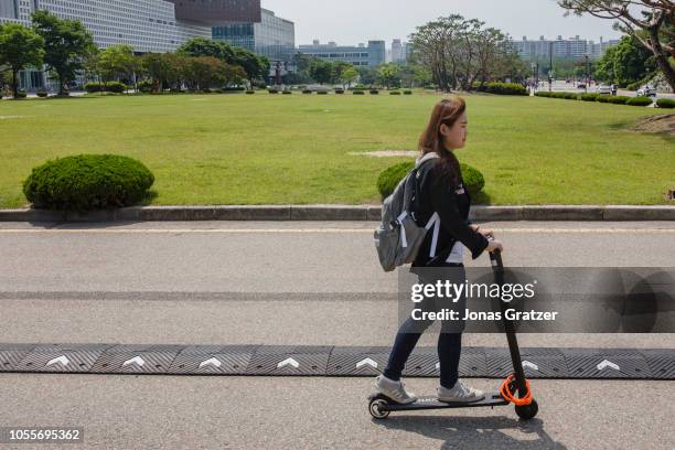Student is traveling on a electric scooter at KAIST , technical university in South Korea.