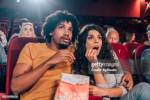 terrified couple at cinema - woman watching horror movie stock pictures, royalty-free photos & images