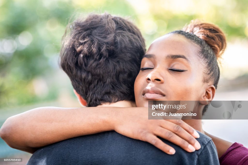 Diverse young couple, they are embracing