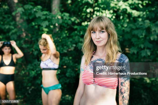 young woman out at lake with friends - people revolutionary front stock-fotos und bilder