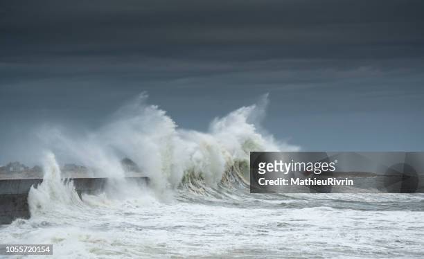 powerful storm against the coast and the harbor in the south of brittany - brittany france stock pictures, royalty-free photos & images