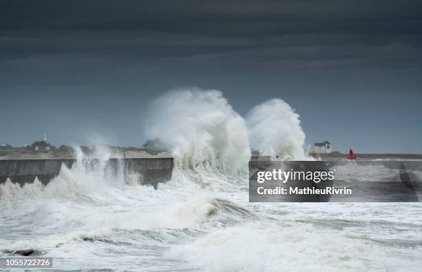 powerful storm against the coast and the harbor in the south of brittany - dique fotografías e imágenes de stock