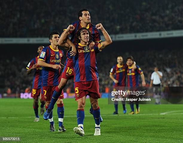 Carles Puyol of Barcelona celebrates scoring his team's second goal with his teammate Sergio Busquets during the La Liga match between Barcelona and...