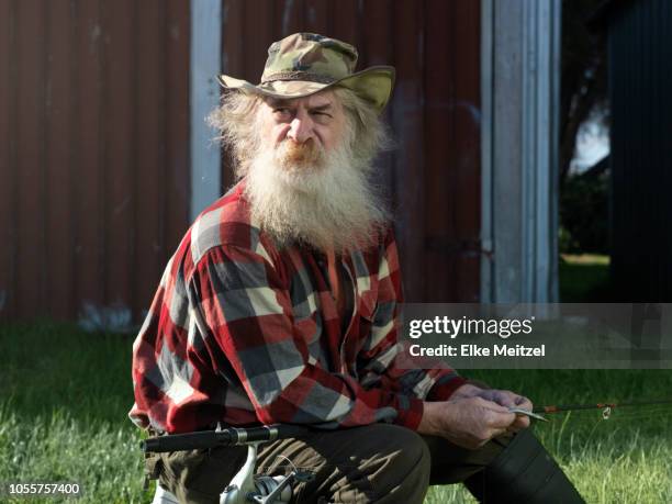 older man with fishing rod and bait - fisherman isolated stock pictures, royalty-free photos & images