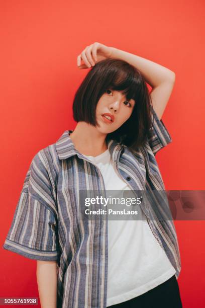 portrait of real woman on red background - chinese model bildbanksfoton och bilder