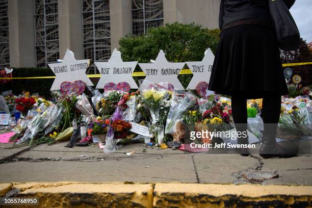 Mourners visit the memorial outside the Tree of Life Synagogue on October 31, 2018 in Pittsburgh, Pennsylvania. Eleven people were killed in a mass...
