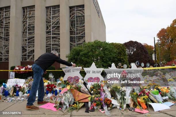 Mourners visit the memorial outside the Tree of Life Synagogue on October 31, 2018 in Pittsburgh, Pennsylvania. Eleven people were killed in a mass...