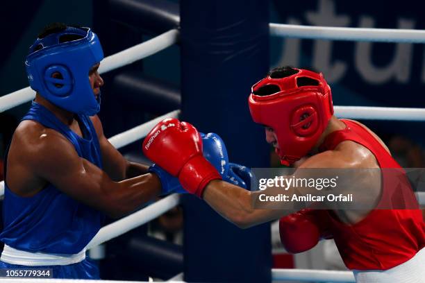 Farid Douibi of Algeria and Jancen Poutoa of Samoa compete in the Men's Middle Semifinal in the Men's Light Welter during day 10 of Buenos Aires 2018...