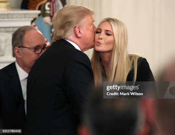 President Donald Trump kisses his daughter and Advisor to the President Ivanka Trump, during an event for American workers in the State Dining Room...