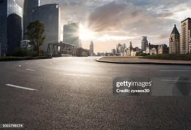 shanghai bund financial district and road. - city street sunset stock pictures, royalty-free photos & images