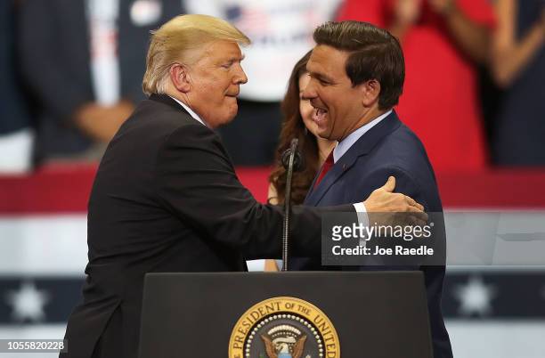 President Donald Trump greets Florida Republican gubernatorial candidate Ron DeSantis during a campaign rally at the Hertz Arena on October 31, 2018...