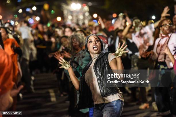 People dressed as zombies dance to Michael Jackson's song Thriller during the annual Village Halloween parade on Sixth Avenue on October 31, 2018 in...
