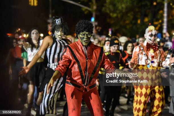 People dressed as zombies dance to Michael Jackson's song Thriller during the annual Village Halloween parade on Sixth Avenue on October 31, 2018 in...