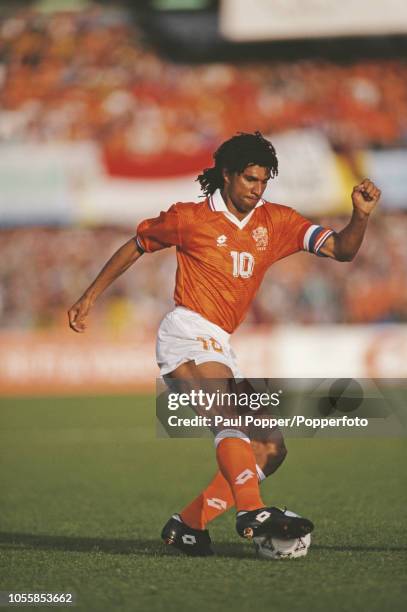 Dutch professional footballer Ruud Gullit, midfielder/forward with AC Milan, pictured in action with the ball for the Netherlands team during play in...