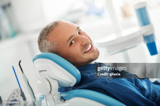 successful dentist appointment. - cadeira de dentista imagens e fotografias de stock
