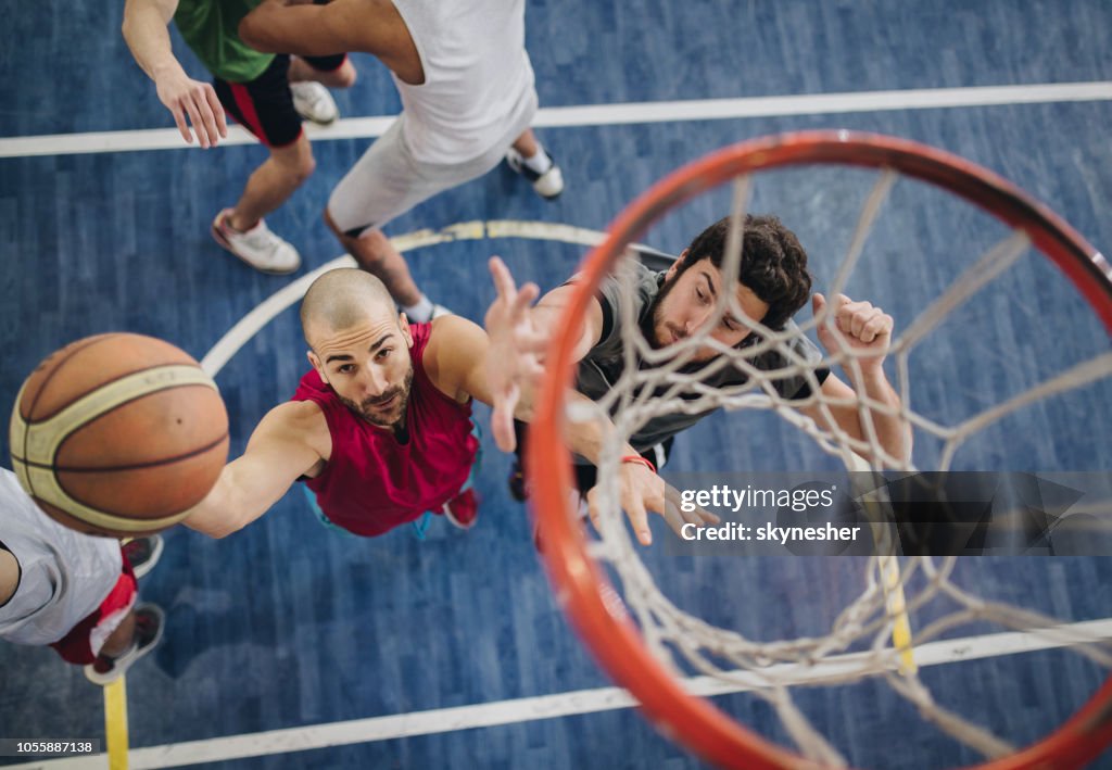 Above view of determined basketball players in action.