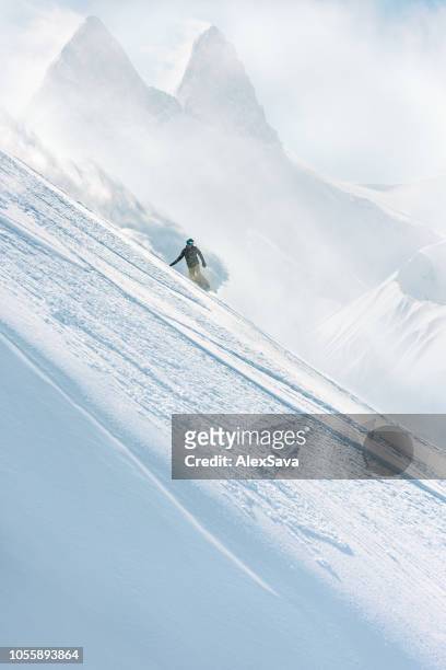 snowboarder riding on steep slope - off piste stock pictures, royalty-free photos & images