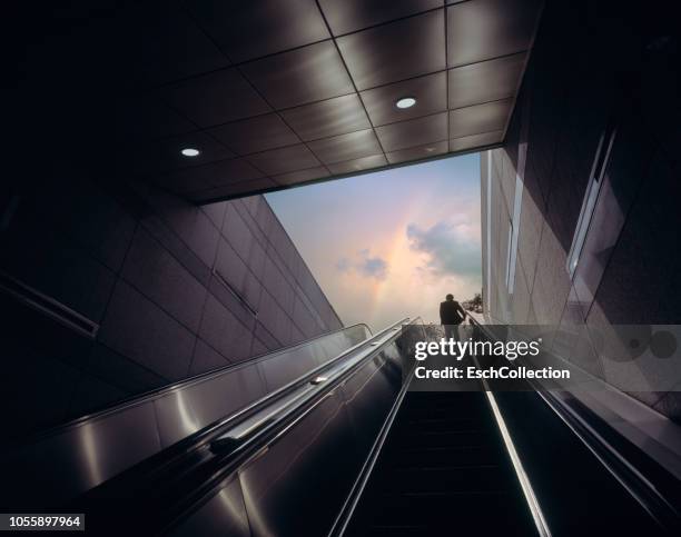 businessman on escalator moving towards sky with rainbow - vision bildbanksfoton och bilder
