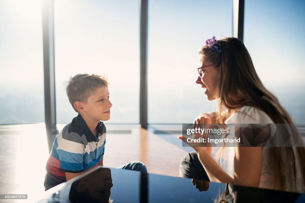 Brother and sister talking in sign language