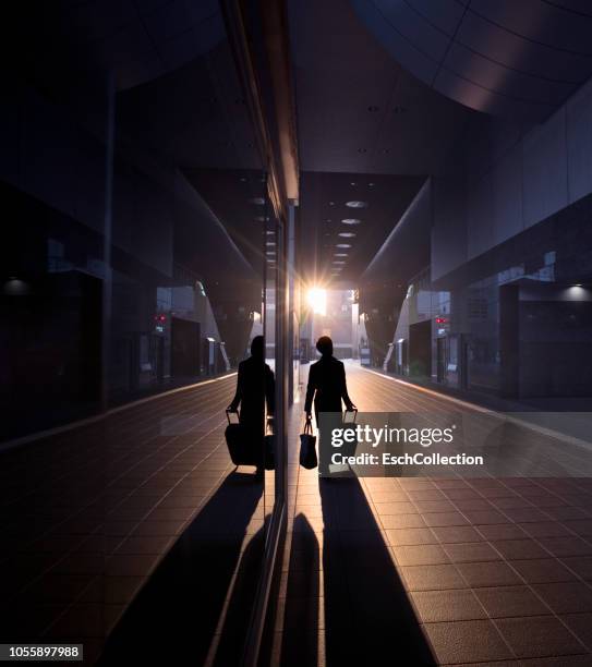 man with suitcase arriving at train station at dawn - morning walk stock pictures, royalty-free photos & images